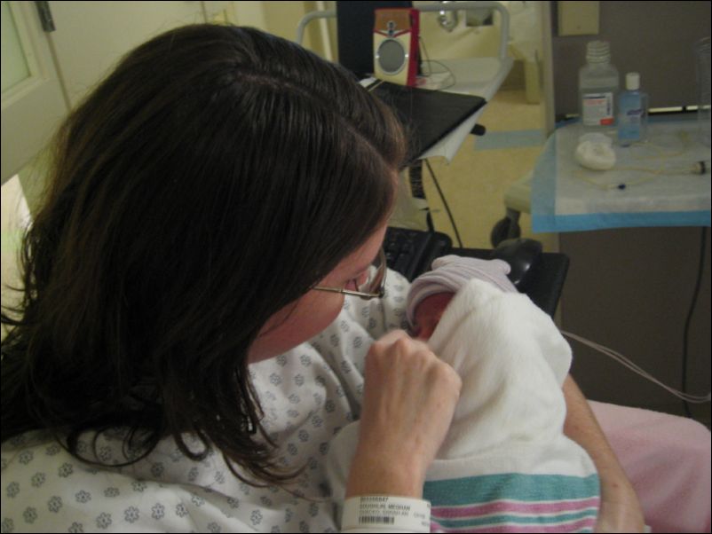Meghan holding Owen for the first time